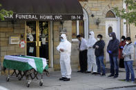 FILE - In this April 22, 2020, file photo, mourners pray as the remains of Traffic Section Commander Mohammed Chowdhury are brought out of the funeral home during his funeral in New York. Chowdhury died on April 19, 2020, from complications related to the coronavirus. Whether it's framed as American exceptionalism, American interventionism, American global standing, or a lack of it, how the world's foremost superpower moves forward following the presidential election will have a sizeable impact in various geopolitical pressure points and in the time of the pandemic. (AP Photo/Seth Wenig, File)
