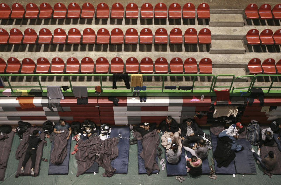 Migrants from Central America, Africa and the Caribbean, who are awaiting their turns to request asylum in the U.S., pass the time inside a shelter in Bachilleres gymnasium in Ciudad Juarez, Mexico, Tuesday, Feb. 19, 2019. Hundreds of migrants, some of whom arrived from the recently closed shelter in Piedras Negras on the Mexico-U.S. border, are camped out in the gym waiting their chance to submit their asylum request at the El Paso port of entry. (AP Photo/Christian Torres)