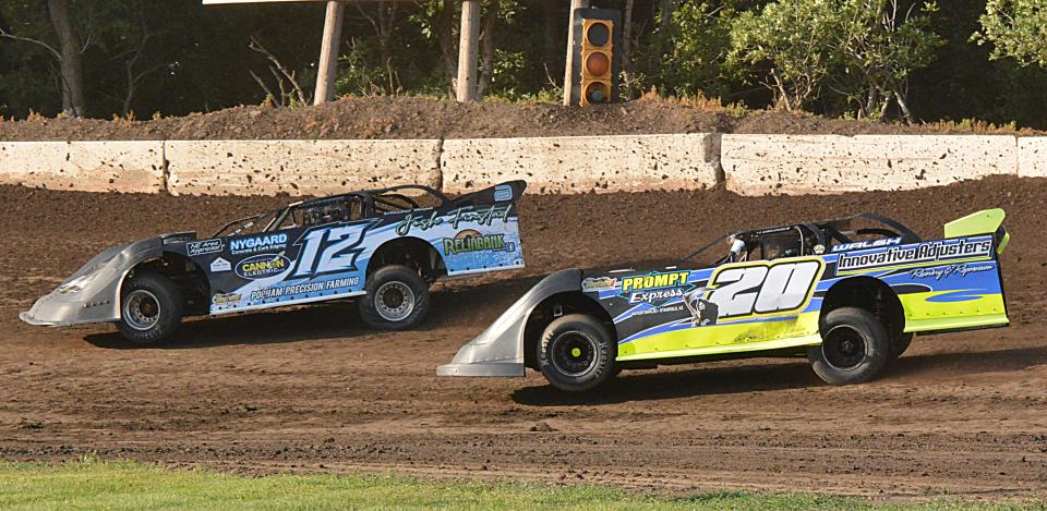 Watertown drivers Trajan Schmidt (12) and Doug Walsh (20) compete in a limited late model heat race at Casino Speedway on Sunday, July 16, 2023. Walsh later won the feature.
