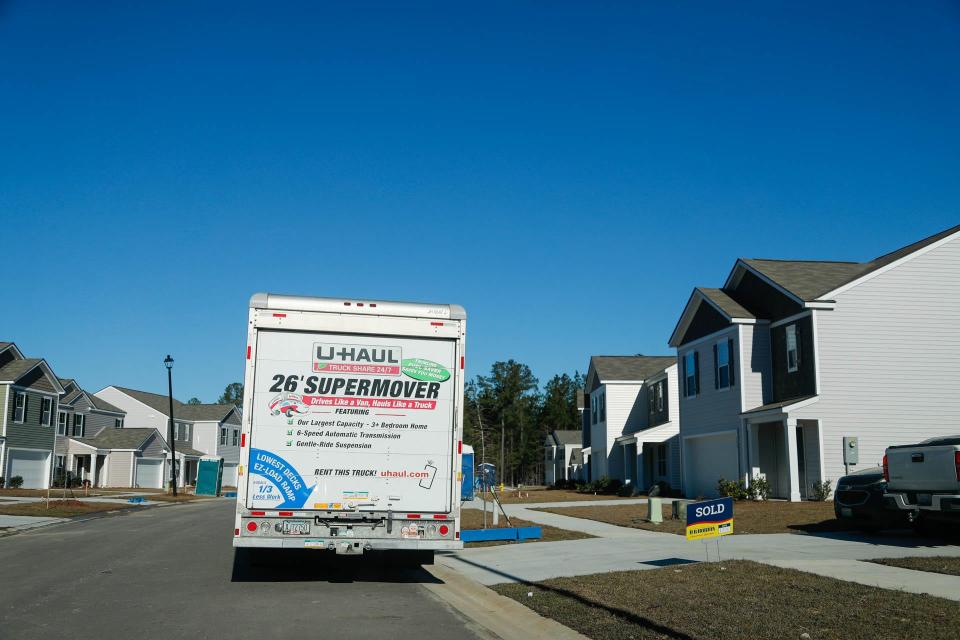 A sold sign and moving truck sit in front of a newly built home in The Pines, a development in the Savannah City limits off of Highgate Boulevard.
