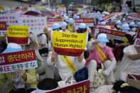 Unification Church followers hold signs during a rally in downtown Seoul, South Korea, Thursday, Aug. 18, 2022, protesting negative Japanese media coverage of their religion after the suspect in the assassination of former Japanese Prime Minster Shinzo Abe blamed the church for his family’s troubles. (AP Photo/Lee Jin-man)