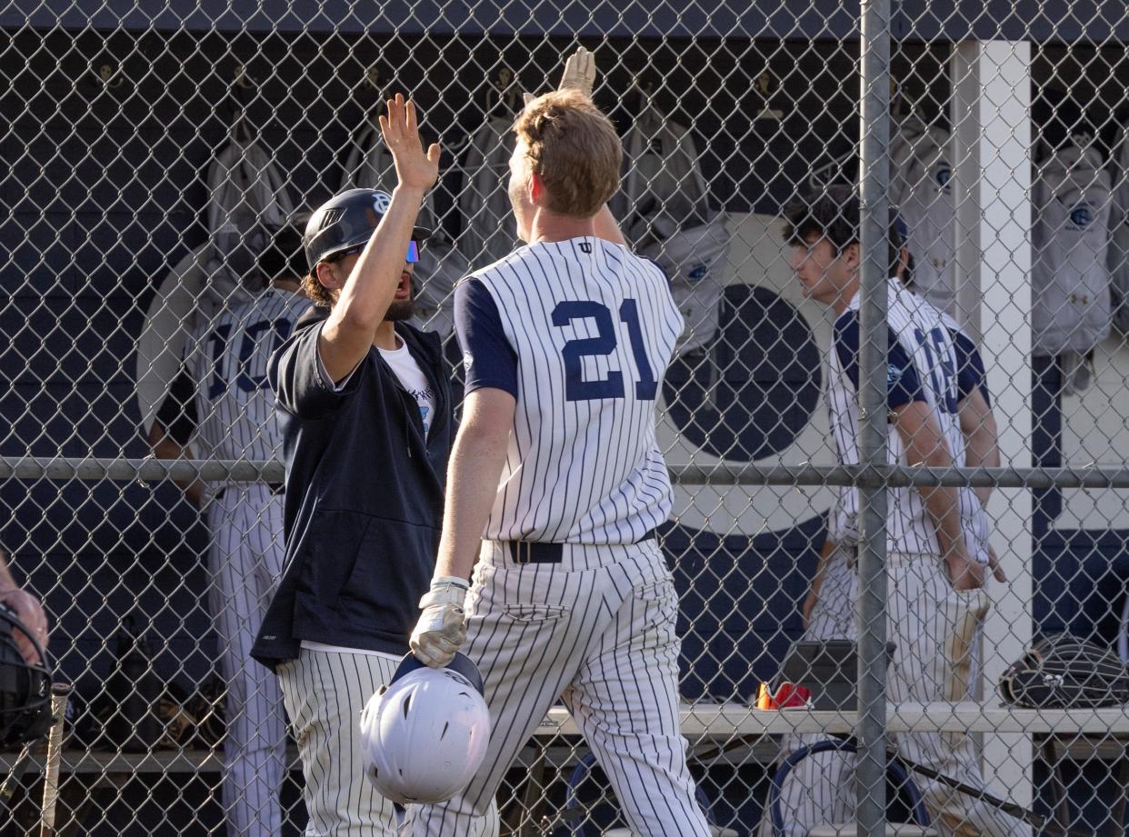 CBA’s Daniel Russo gets a high five after scoring in the sixth inning. Christian Brothers Academy baseball defeats Middletown South on April 9, 2024 in Middletown, NJ.
