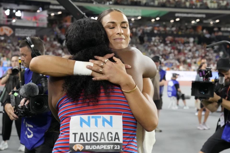 Silver medalist Valarie Allman, of the United States, hugs gold medalist Laulauga Tausaga, also of the United States, after the Women's discus throw final during the World Athletics Championships in Budapest, Hungary, Tuesday, Aug. 22, 2023. (AP Photo/Matthias Schrader)