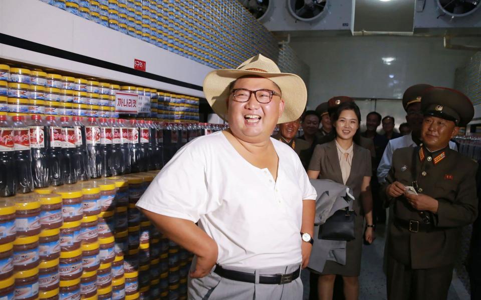 Kim Jong-un,is pictured in his undershirt on a visit to a factory. (AP Images)