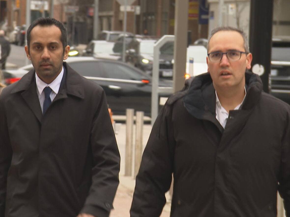 Umar Zameer, left, with his defence lawyer Nader Hasan, walking into court in downtown Toronto on April 2. On Tuesday, Zameer said he told his wife to call the police as he tried to exit the parking garage, thinking police would 'save them.' (Paul Smith/CBC - image credit)