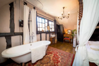 <p>I would keep one eye open if you’re relaxing in the tub of this haunted chamber. (Airbnb) </p>