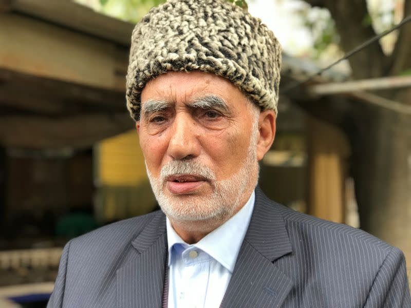 Gassan Akhmedov, an 80-year-old elder of a refugee neighbourhood, talks to a reporter outside his home in Baku