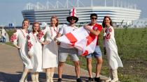 <p>Two England fans pose with locals ahead of the stadium in Kalingrad </p>