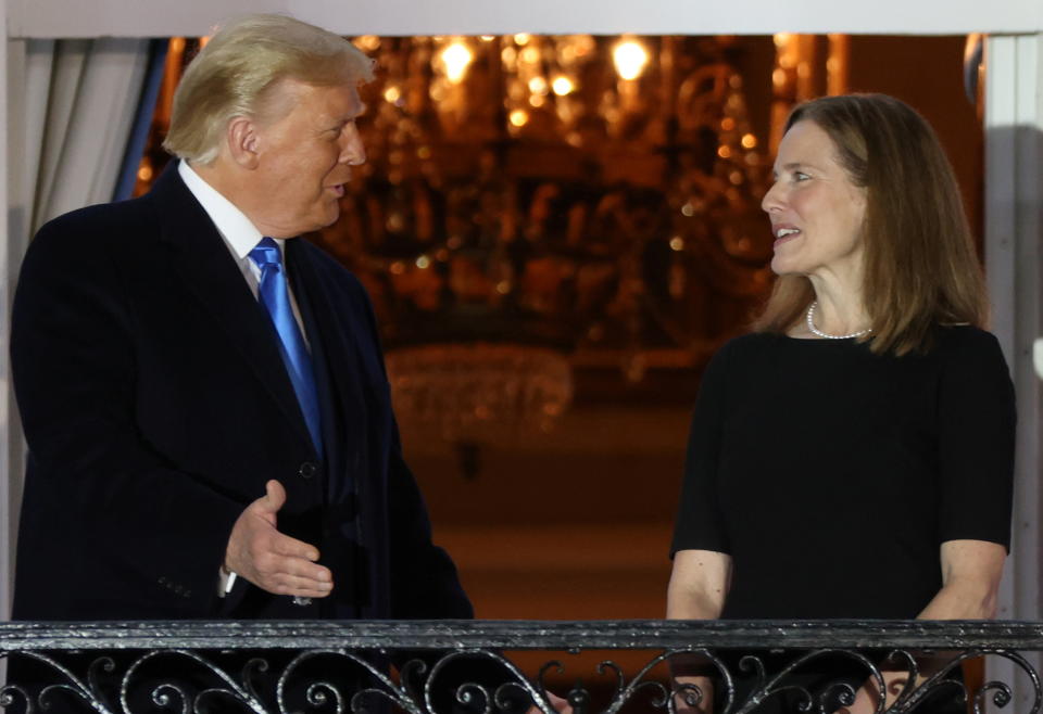 U.S. President Donald Trump speaks with Judge Amy Coney Barrett after she was sworn in as an associate justice of the U.S. Supreme Court on the South Lawn of the White House in Washington, U.S. October 26, 2020.  REUTERS/Jonathan Ernst