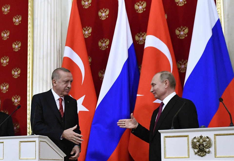 Russian President Vladimir Putin, right, and Turkey's President Recep Tayyip Erdogan prepare to shake hands after their joint news conference following the talks in the Kremlin in Moscow, Russia, Wednesday, Jan. 23, 2019. Russia and Turkey are jockeying for clout in Syria as the U.S. plans to withdraw its troops from the country. (Alexander Nemenov/Pool Photo via AP)