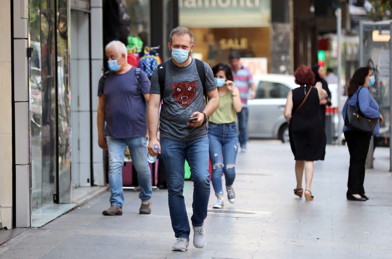 People walk as they wear face masks to prevent the spread of the coronavirus disease (COVID-19) in Beirut