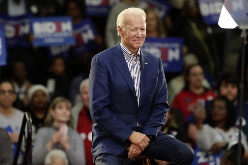 FILE - In this Feb. 29, 2020, file photo Democratic presidential candidate former Vice President Joe Biden smiles at supporters during a campaign event at Saint Augustine's University in Raleigh, N.C. Biden has won the last few delegates he needed to clinch the Democratic nomination for president. (AP Photo/Gerry Broome, File)