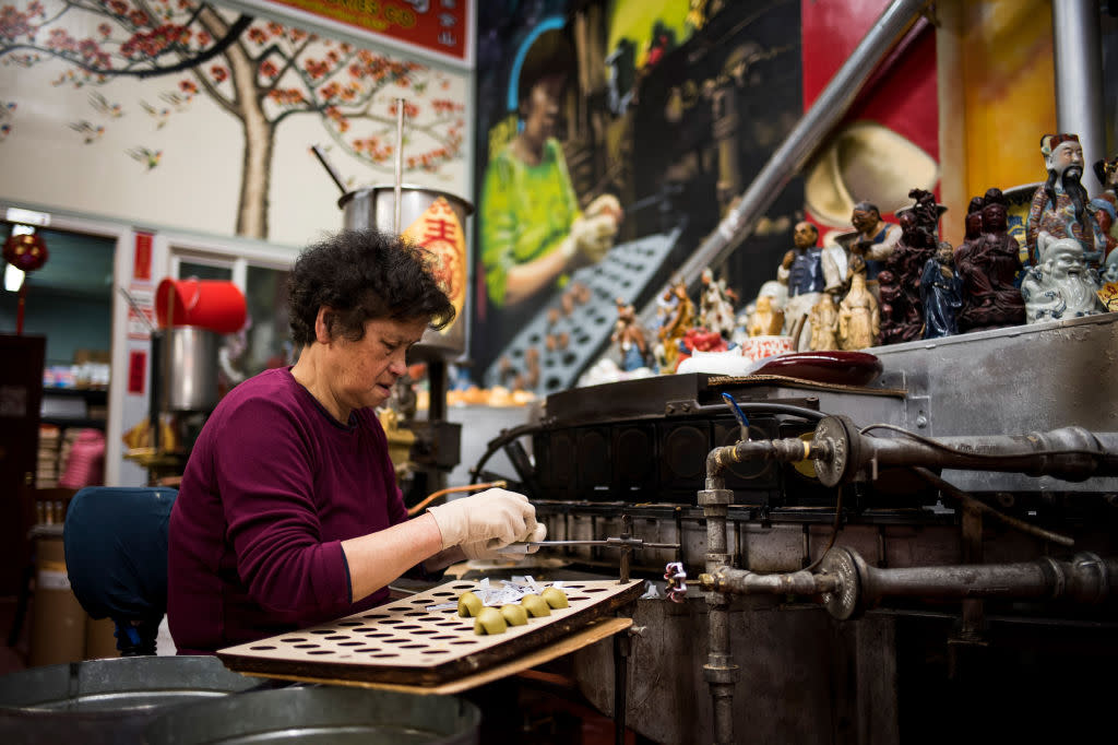 A worker puts a fortune slip inside a fortune cookie at the Golden Gate Fortune Cookie Factory ahead of Lunar New Year in the Chinatown neighborhood of San Francisco, California, U.S., on Wednesday, Jan. 22, 2020. Also known as Chinese New Year or the Spring Festival, it marks the beginning of theÂ lunar calendarÂ and is China's most important holiday, a period that's seen as celebrating values like unity and family ties. Photographer: David Paul Morris/Bloomberg