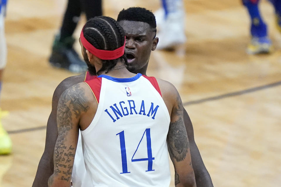 New Orleans Pelicans forward Zion Williamson, right, celebrates with forward Brandon Ingram (14) in the second half of an NBA basketball game against the Boston Celtics in New Orleans, Sunday, Feb. 21, 2021. (AP Photo/Gerald Herbert)