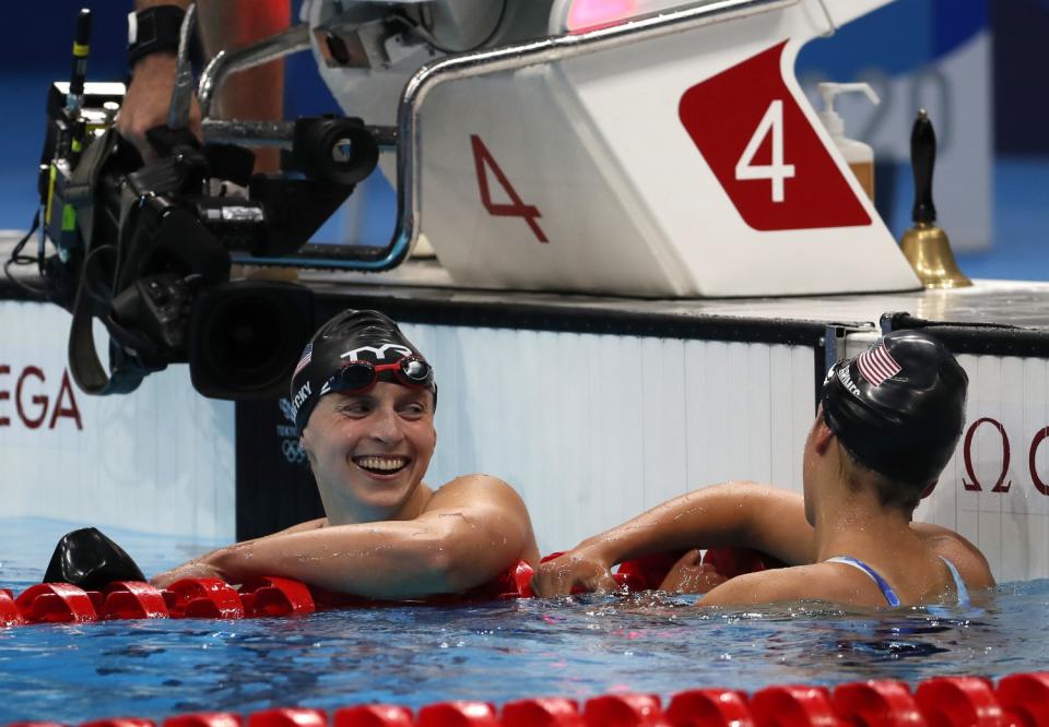 Katie Ledecky smiles while speaking with U.S. teammate Katie Grimes.