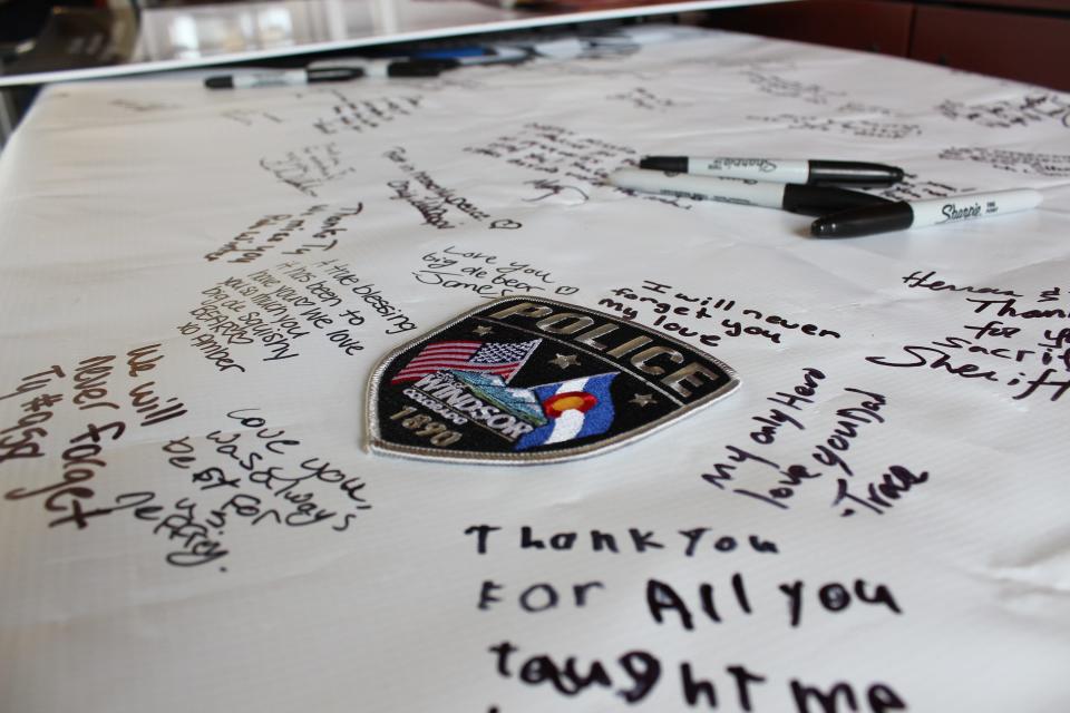 People write memorial messages to Ty Powell, the Windsor police officer who died from COVID-19 on Oct. 13, 2021, at the Ride to Remember at the Windsor Police Department on Aug. 15, 2022.