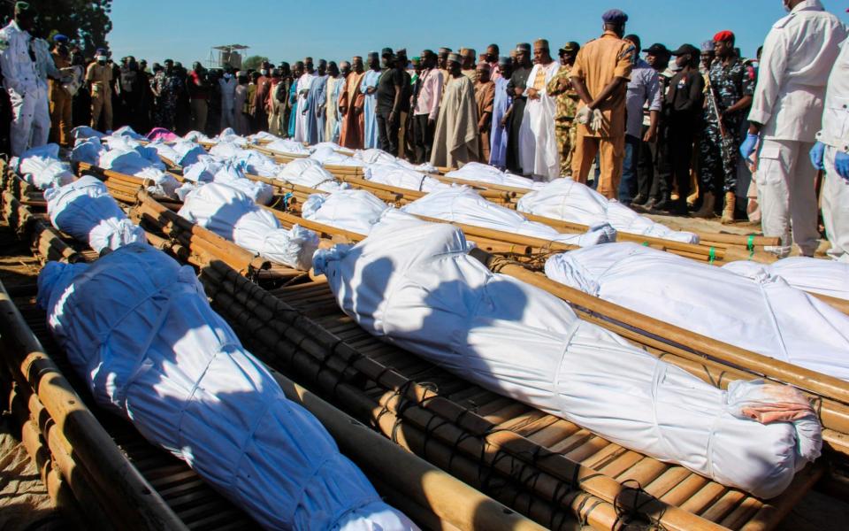 Mourners attend the funeral of 43 farm workers in Zabarmari, Nigeria - AUDU MARTE /AFP