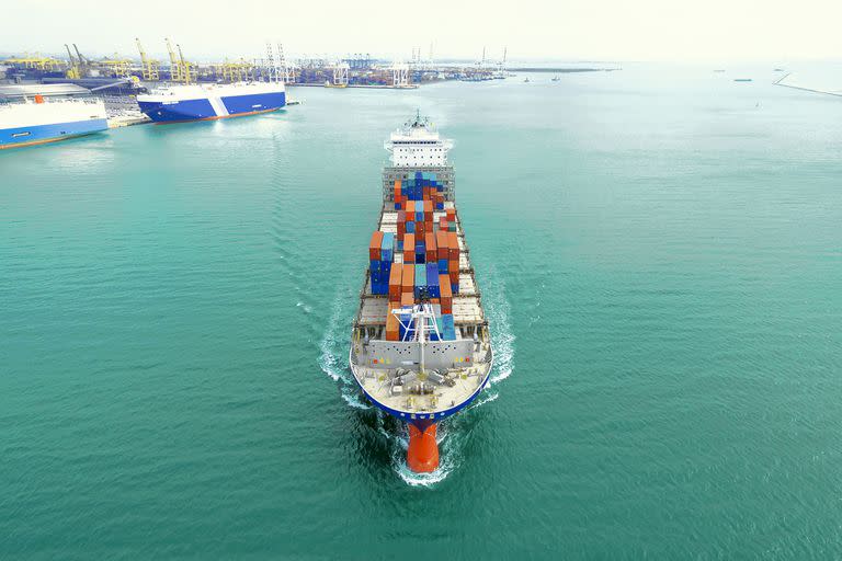 container ship being shipping out of stock port by sea, thailand.