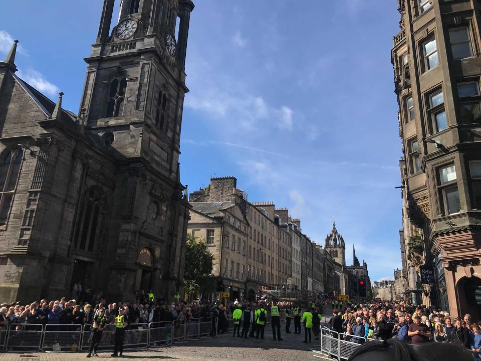 Crowds throng Edinburgh’s Royal Mile, where the Queen’s coffin will shortly be taken to St Giles’ Cathedral (pictured) (Holly Bancroft/The Independent)