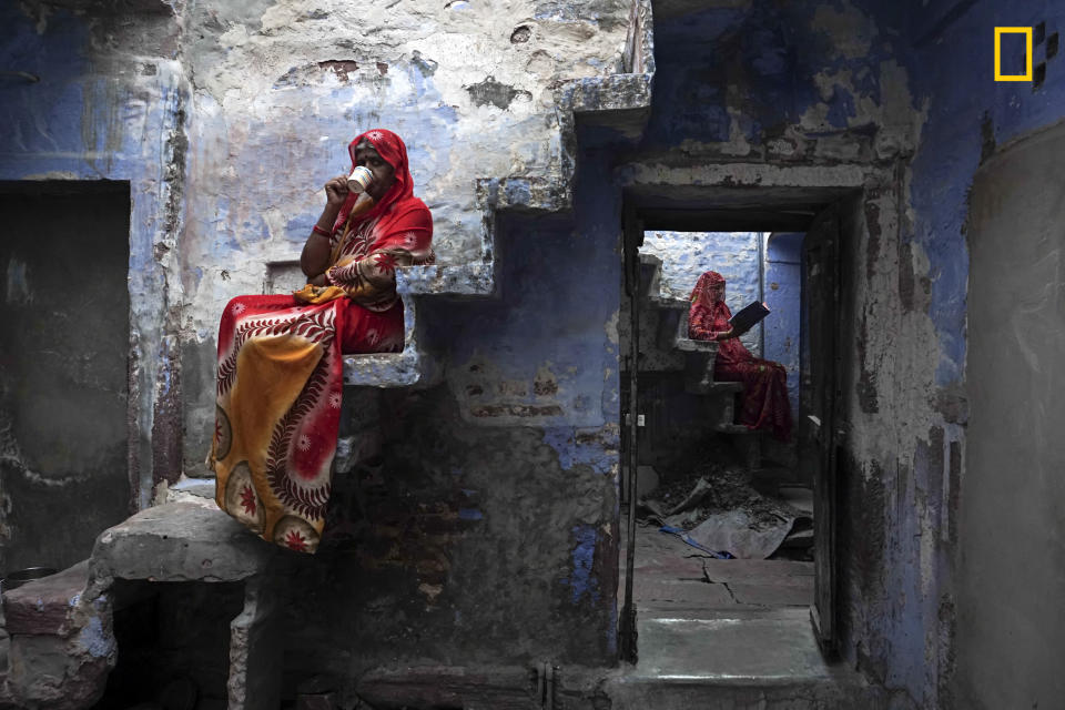 <p>“These Rajasthani sisters were sitting on the staircase inside their house relaxing and enjoy a cup of masala chai.” (© Firdaus Hadzri/National Geographic Travel Photographer of the Year Contest) </p>