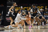 California Baptist guard Anaiyah Tu'ua, left, and Stephen F. Austin guard Avery VanSickle (3) battle for the ball during the first half of an NCAA college basketball game in the championship of the Western Athletic Conference women's tournament, Saturday, March 16, 2024, in Las Vegas. (AP Photo/David Becker)