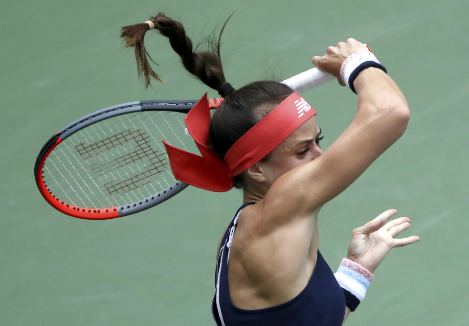 Nicole Gibbs, of the United States, returns a shot to Simona Halep, of Romania, during the first round of the US Open tennis tournament Tuesday, Aug. 27, 2019, in New York. (AP Photo/Kevin Hagen)