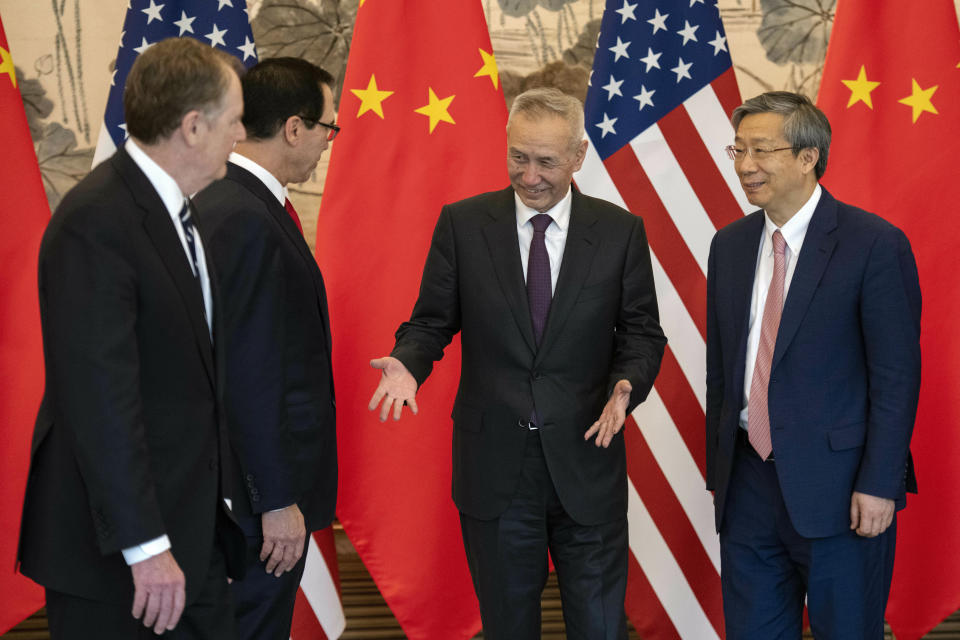 China's Vice Premier Liu He, second right, gestures next to U.S. Treasury Secretary Steven Mnuchin, second left, and Yi Gang, right, governor of the People's Bank of China (PBC) as U.S. Trade Representative Robert Lighthizer looks on after they posed for a group photo at Diaoyutai State Guesthouse in Beijing Friday, March 29, 2019. (Nicolas Asfouri/Pool Photo via AP)