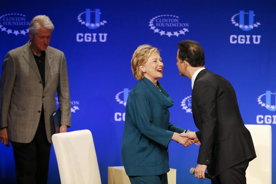 Former Secretary of State Hillary Rodham Clinton, center, greets talk show host Jimmy Kimmel as former President Bill Clinton, left, stands near during a student conference for the Clinton Global Initiative University, Saturday, March 22, 2014, at Arizona State University in Tempe, Ariz. More than 1,000 college students are gathered at Arizona State University this weekend as part of the Clinton Global Initiative University's efforts to advance solutions to pressing world challenges. (AP Photo/Matt York)