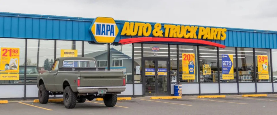 The exterior of a NAPA Auto Parts store   successful  Portland, Oregon with a pickup motortruck  parked retired  front