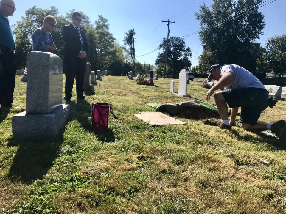 Montgomery County Coroner Alexander Balacki (far right) stands with the family of Roscoe Fellman whose ashes were interred in his parents grave on Sept. 25, 2019. He died in 2014.