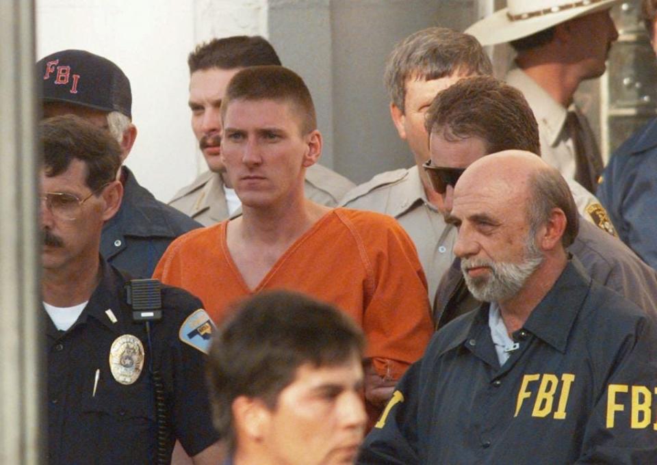 Oklahoma City bomber Timothy McVeigh is escorted by law enforcement officials from the Noble County Courthouse in Perry, Okla., on April 21, 1995. The bombing of the Alfred P. Murrah Federal Building on April 19 claimed the lives of 168 people. McVeigh was tried, found guilty and received the death penalty from a jury in Denver on June 13, 1997.