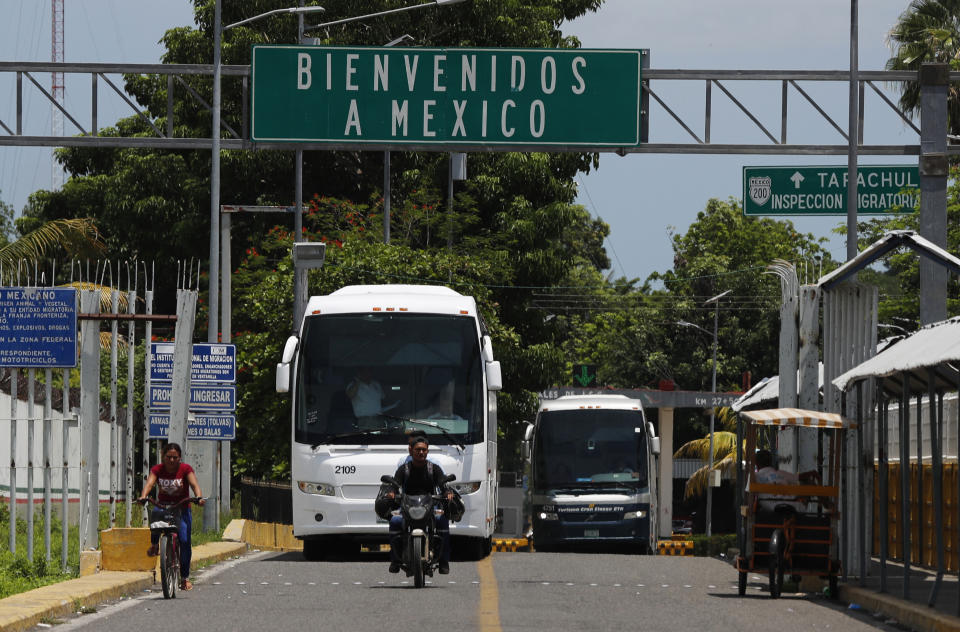 A sign reads in Spanish "Welcome to Mexico" on the bridge above the Suchiate River, on the Guatemala–Mexico border, near Ciudad Hidalgo, Mexico, Thursday, June 6, 2019. Local authorities say the bus is carrying Central American migrants back to Guatemala, one day after Mexican police and immigration agents blocked the advance of about 1,000 Central American migrants who were walking along a highway. (AP Photo/Marco Ugarte)