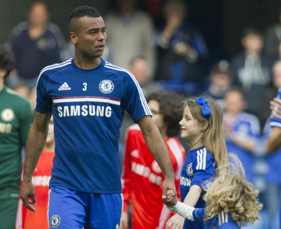 Chelsea's Ashley Cole, walks around the pitch with his children at the end of their English Premier League soccer match against Norwich City, at the Stamford Bridge Stadium in London, Sunday, May 4, 2014. (AP Photo/Bogdan Maran)