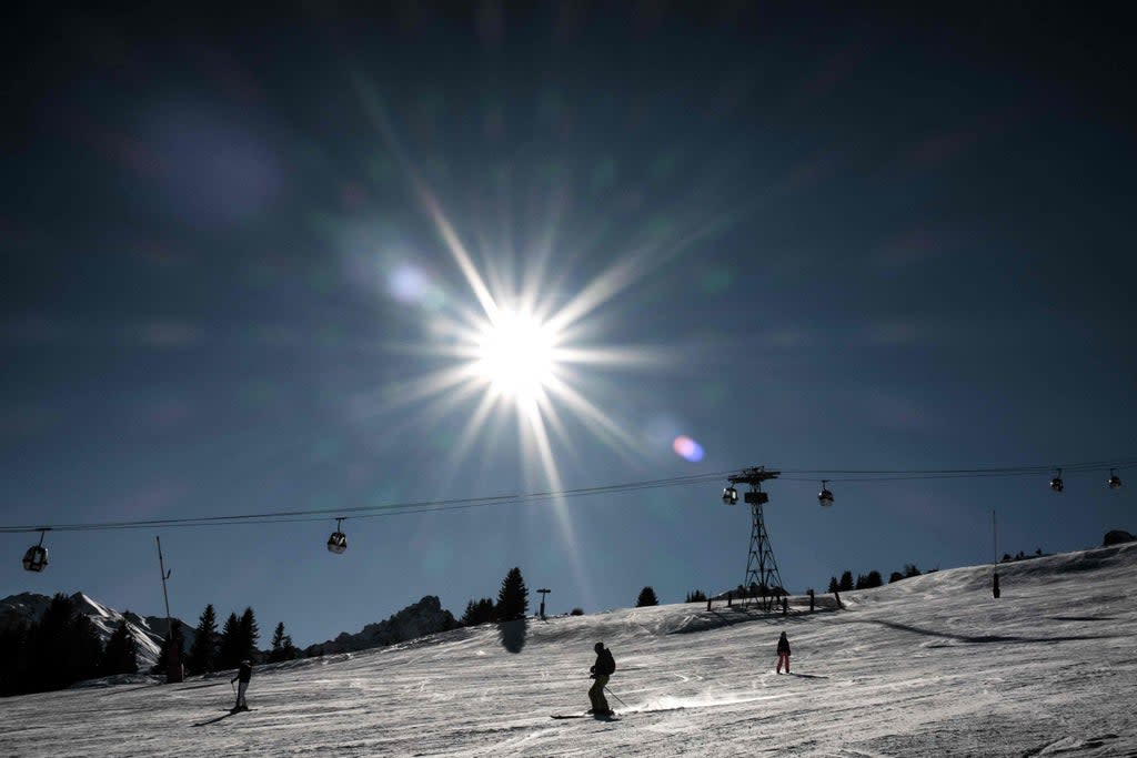 Skiers ride down a slope in the French Alps (AFP via Getty Images)