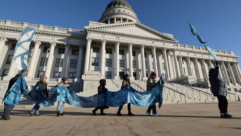 Members of the Great Salt Lake vigil group walk the grounds of the Capitol in Salt Lake City on Tuesday, Jan. 30, 2024. The group walks around the grounds every morning as part of the vigil.
