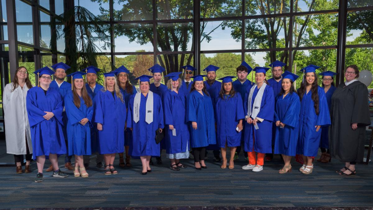 Graduates of Blue Ridge Community College's Adult High School and High School Equivalency programs proudly pose together after their graduation ceremony. Front row, from left are: Sam Stroup; Leah Parris; Cayla Owen; Ivannia Artavia Hollingsworth; Melissa Leigh Dombrowski; Nelly Cecilia Diaz Sarmiento; Gladis Cortes Ojeda; Diana de Pilar Carvajal Rueda; Nalleli Guzman; Monica Aguilar; and E. Grace Solle, faculty. Back row, from left are: Erin Dula, faculty; Alvaro Javier Villamizar Guerrero; Dagoberto Sandoval Reyes; Javiera Pizarro-Huerta; Celeste Kelly; Angel Guerra; Edgar Garrido; William Harris Hilyer; Aaron Alexander Heatherly; and Marcela Basto Jaramillo. Not pictured, Ellizabeth Hernandez.