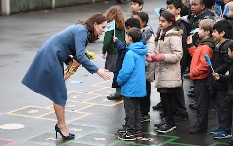 Duchess of Cambridge greets children, who are waving Heads Together flags - Credit: Joe Giddens/PA