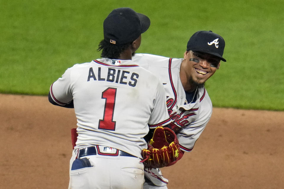 Atlanta Braves' Orlando Arcia, right, and Ozzie Albies (1) celebrate after getting the final out of a baseball game against the Pittsburgh Pirates in Pittsburgh, Tuesday, Aug. 8, 2023. The Braves won 8-6. (AP Photo/Gene J. Puskar)