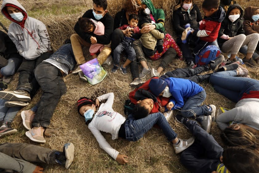 Asylum seekers detained by Border Patrol, including minors and babies, sleep on the ground.