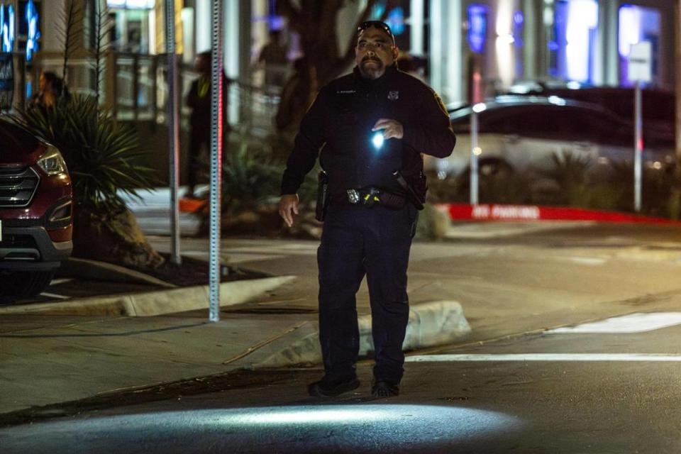 A Fort Worth Police Department officer shines his flashlight while supervising the crowds on Foch Street located in the West 7th District in Fort Worth on Friday, March 22, 2024. Out of a total of 3,197 crimes reported in Fort Worth’s entertainment districts from Jan. 1, 2023, to March 10, 2024, the largest number happened in the West 7th area, totaling 1,288. Chris Torres/ctorres@star-telegram.com