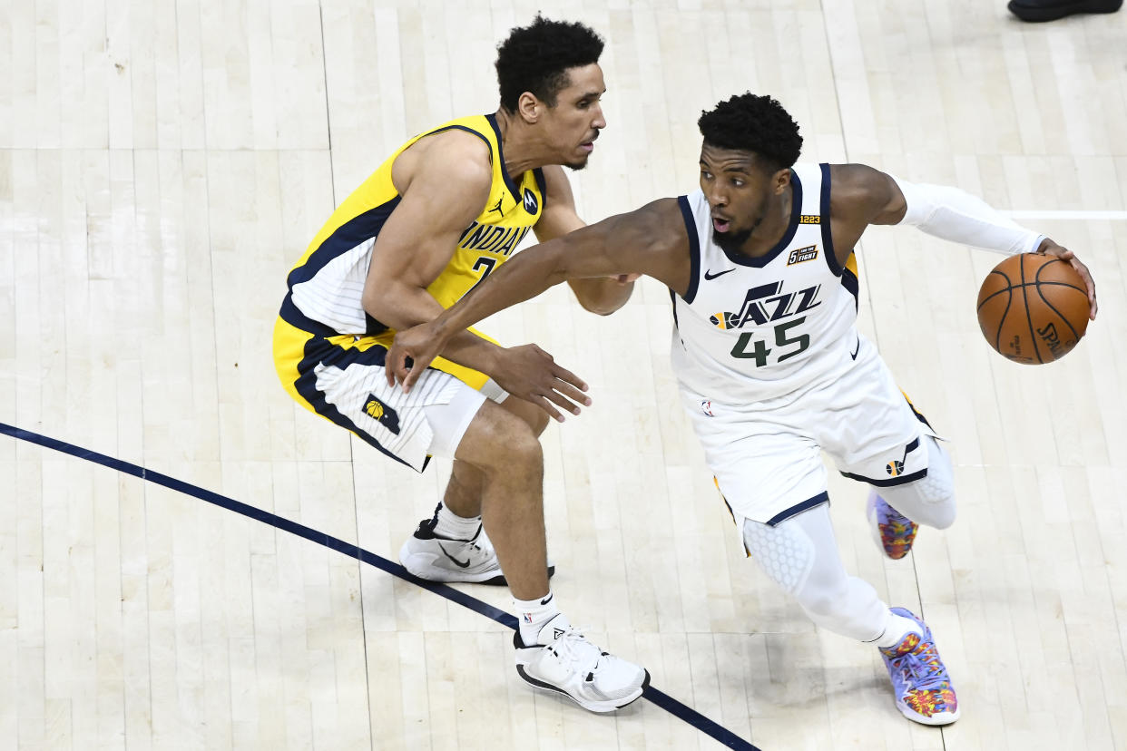 Donovan Mitchell of the Utah Jazz drives past Malcolm Brogdon of the Indiana Pacers