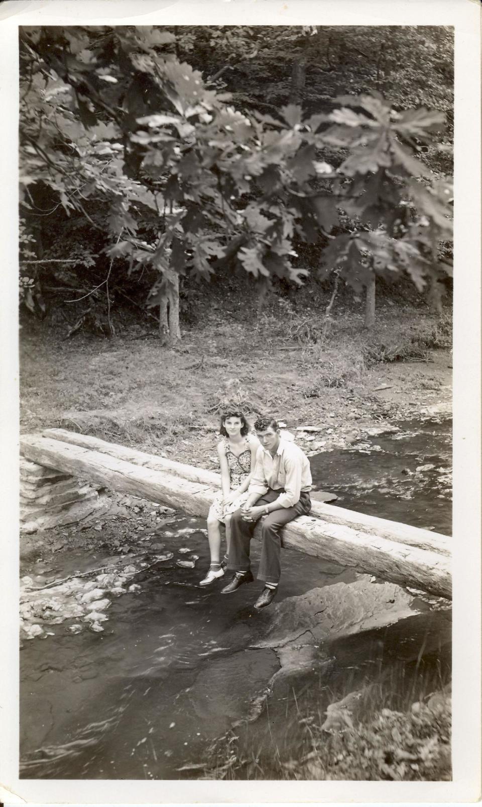 In this September 1940 photo provided by Dick Felumlee, Kenneth and Helen Felumlee of Nashport in central Ohio are shown sitting on a log north of Zanesville about four years before their marriage. The Felumlees, who celebrated their 70th wedding anniversary in February, died 15 hours apart from each other last week. (AP Photo/Felumlee family)