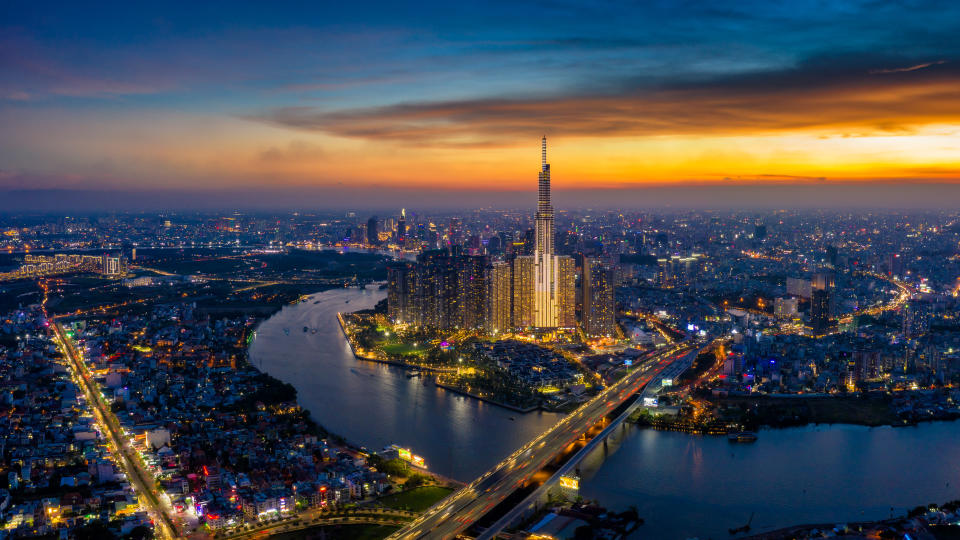 Aerial view of Ho Chi Minh City skyline and skyscrapers in center of heart business at Ho Chi Minh City downtown. Panorama of cityscape on Saigon river in Ho Chi Minh City at Vietnam at sunset scene