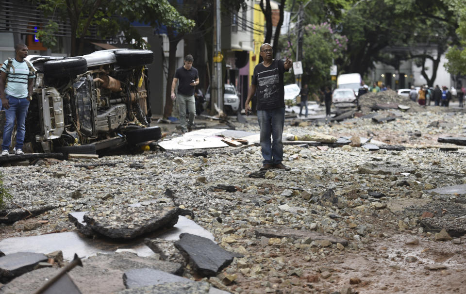 A man stands in a street destroyed by floods in Belo Horizonte, Minas Gerais state, Brazil, Wednesday, Jan. 29, 2020. Heavy rains devastated the Brazilian state of Minas Gerais on Tuesday night and Wednesday morning, causing destructive flooding and landslides. (AP Photo/Gustavo Andrade)