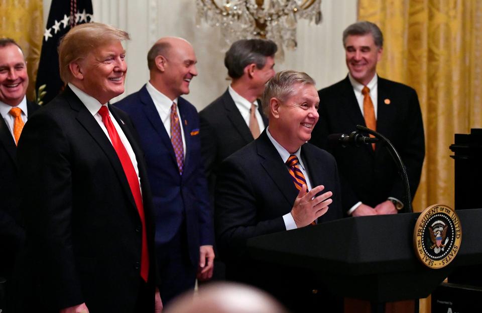 President Donald Trump looks on as Senator Lindsey Graham speaks at a January ceremony honoring the college football champion Clemson Tigers at the White House.