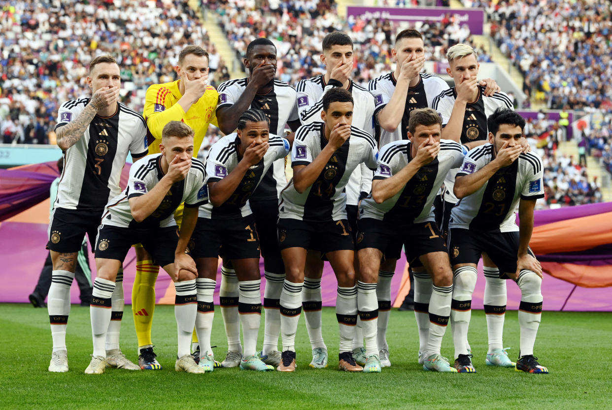 Soccer Football - FIFA World Cup Qatar 2022 - Group E - Germany v Japan - Khalifa International Stadium, Doha, Qatar - November 23, 2022 Germany players cover their mouths as they pose for a team group photo before the match REUTERS/Annegret Hilse     TPX IMAGES OF THE DAY