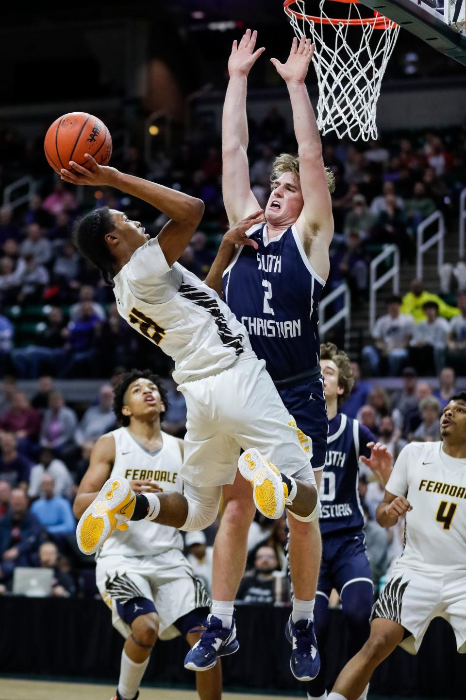 Ferndale guard Markiese Young (21) makes a jump shot against Ferndale guard Caleb Renfroe (2) during the second half of MHSAA boys Division 2 final at Breslin Center in East Lansing on Saturday, March 25, 2023.