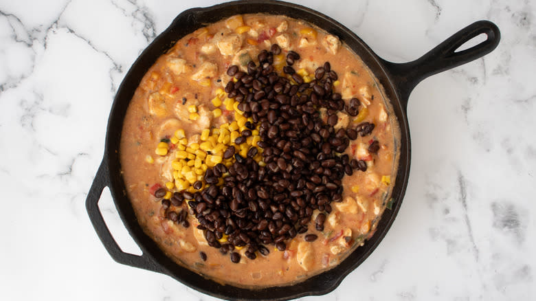 corn and beans in skillet with pot pie filling