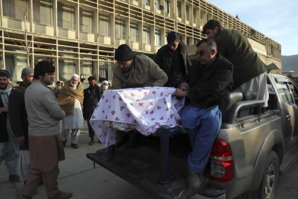 CORRECTS DATE OF ATTACK AND IDENTIFIES RASHEED AS THE HEAD OF THE INDEPENDENT ELECTIONS WATCHDOG -- Afghans carry the coffin of Mohammad Yousuf Rasheed, executive director of the non-governmental Free and Fair Election Forum of Afghanistan, during his funeral ceremony, in Kabul, Afghanistan, Wednesday, Dec. 23, 2020. Separate bombing and shooting attacks in Afghanistan’s capital left several people dead Wednesday, including Rasheed, the head of the independent elections watchdog, officials said. (AP Photo/Rahmat Gul)