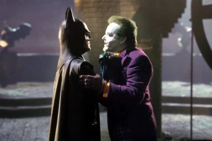 Michael Keaton grabs Jack Nicholson's Joker by the chest in Batman.